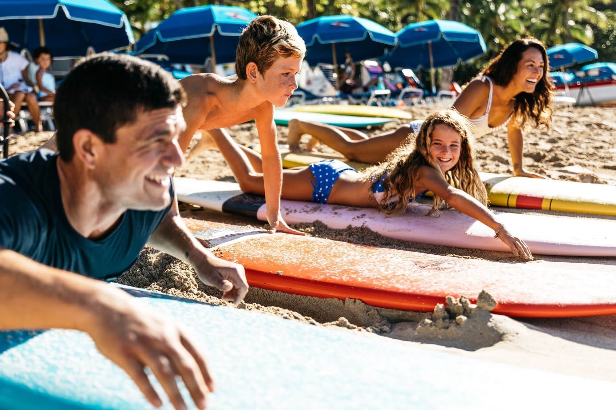 A family enjoying on the beach in Haleiwa Beach near Waikiki Resort Hotel