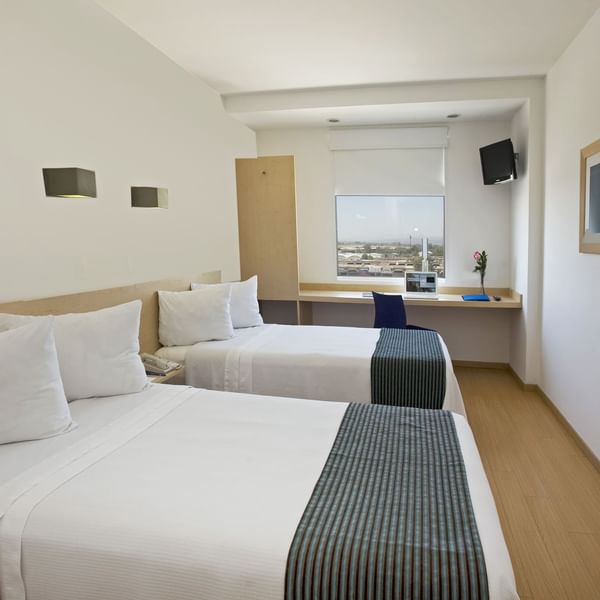 2 double beds with a working area in Superior Room, One Hotels