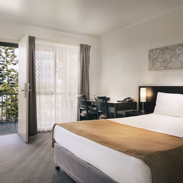 Standard Room with queen bed, work desk, lamp & balcony with greenery view at Mercure Townsville