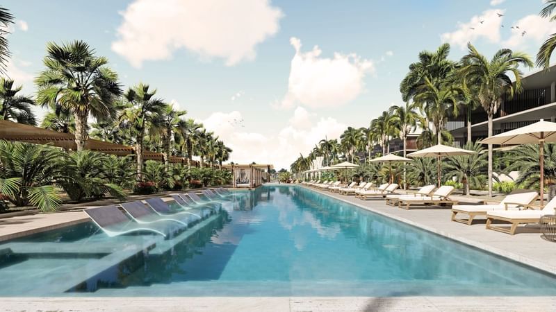 Swimming pool, sun loungers with canopies & palm trees in Fiesta Americana Travelty