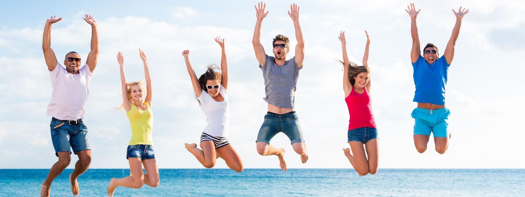 Group of friends having fun on beach at Daydream Island Resort