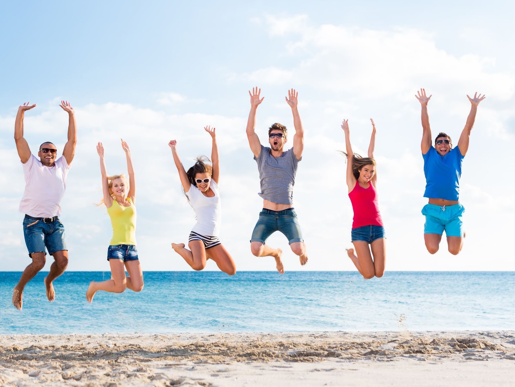 Group of friends having fun on beach at Daydream Island Resort