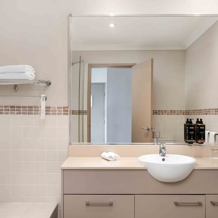 studio bathroom with large vanity and mirror