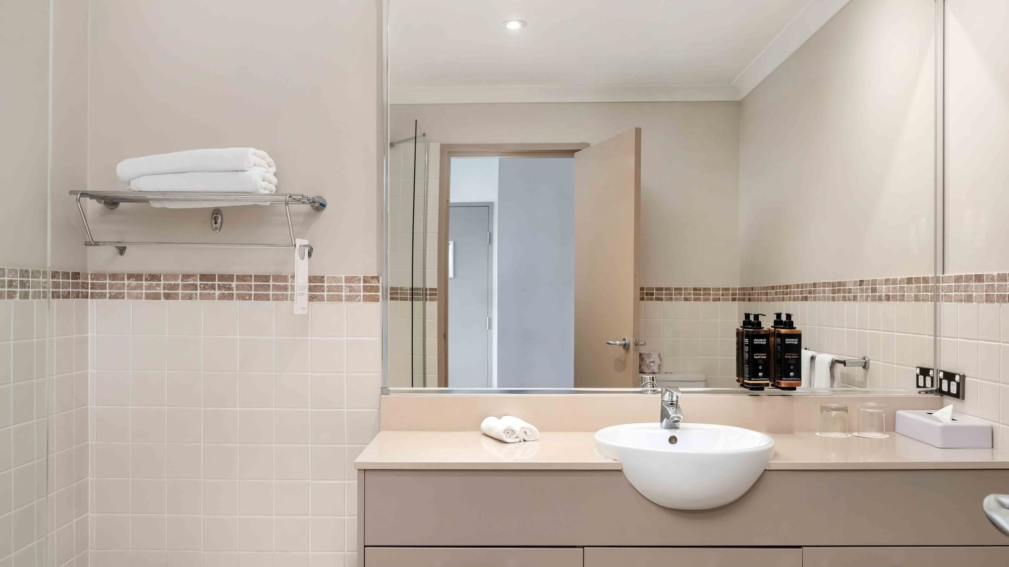 studio bathroom with large vanity and mirror
