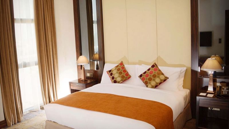 Cozy bedroom with vintage interior & decor in Ambassador Suite at Warwick Al Khobar