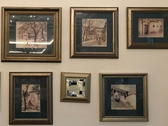 Framed paintings by George Smirnoff hang at Artyzen Grand Lapa