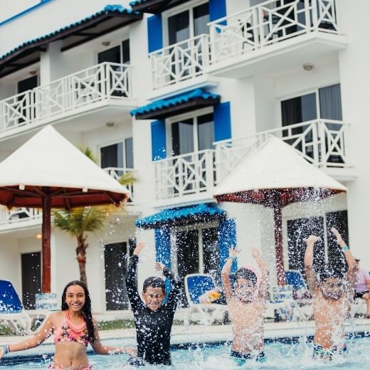 Kids playing in the outdoor pool at Playa Blanca Beach Resort