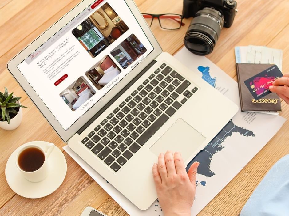 Close-up of person booking online form a laptop at Nostalgia Hotel Singapore