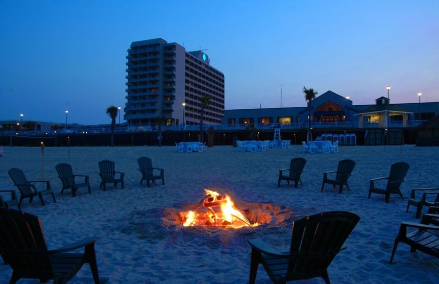 Bonfire night on the beach with chairs at Ocean Place Resort
