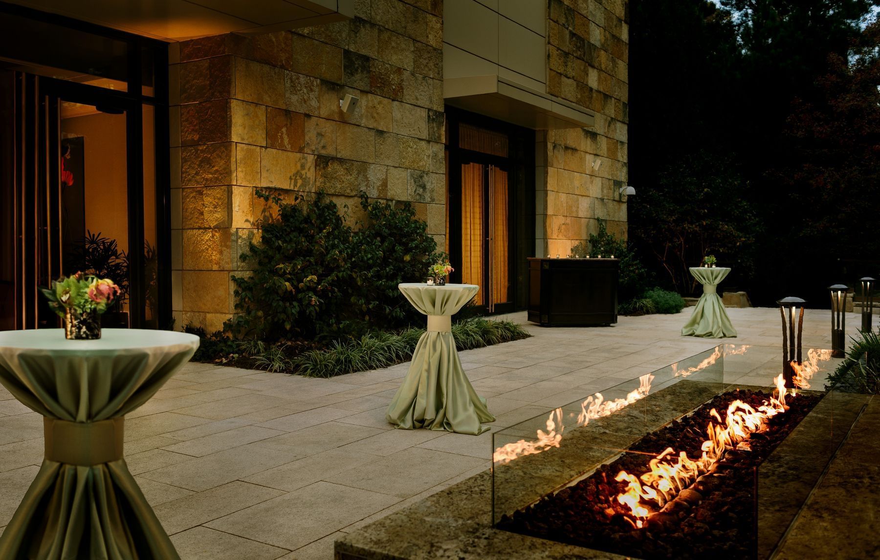 A patio featuring a fire pit & table set up outside the ballroom at Umstead Hotel and Spa