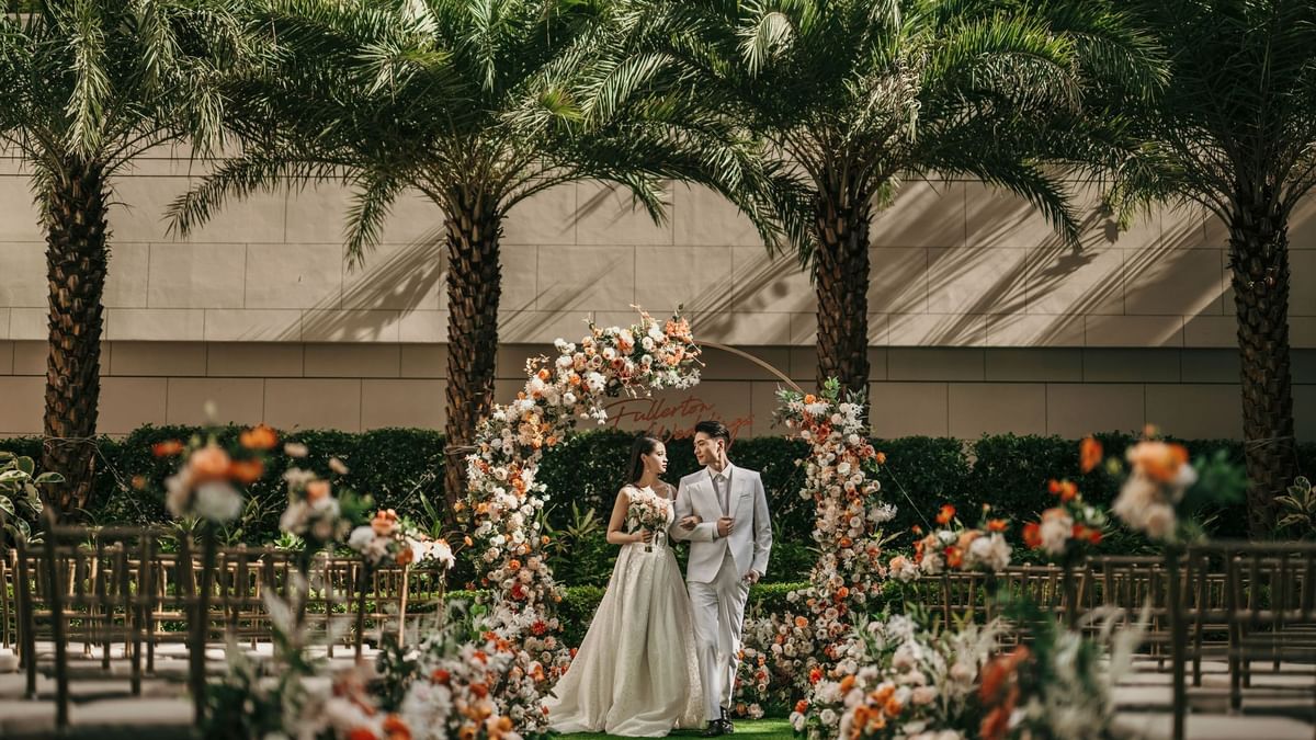 Couple walking down the aisle in an outdoor wedding reception at Ocean Park Hotel Hong Kong