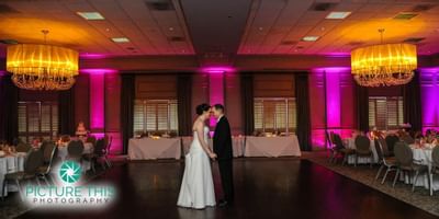 A wedding couple in the ballroom at Ethan Allen Hotel