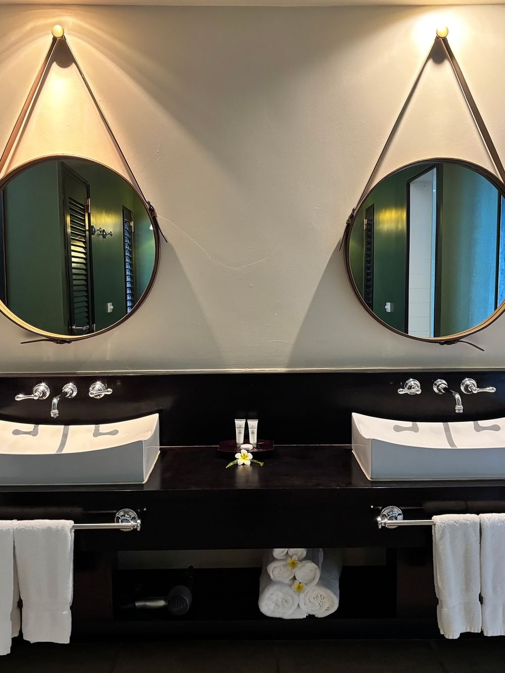 Two sinks with towels and toiletries in a bathroom at Warwick Le Lagon - Vanuatu in Efate.