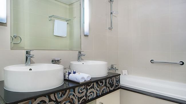 Bathroom vanity and bath rub in Deluxe Room at DAMAC Maison Dubai Mall Street