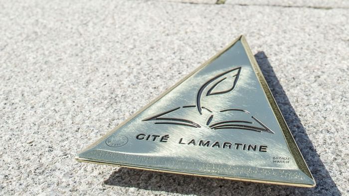 Closeup of a badge of Cite Lamartine near Originals Hotels