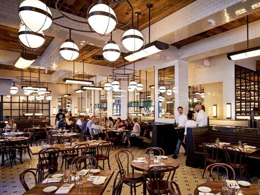 a large dining room with many tables and chairs