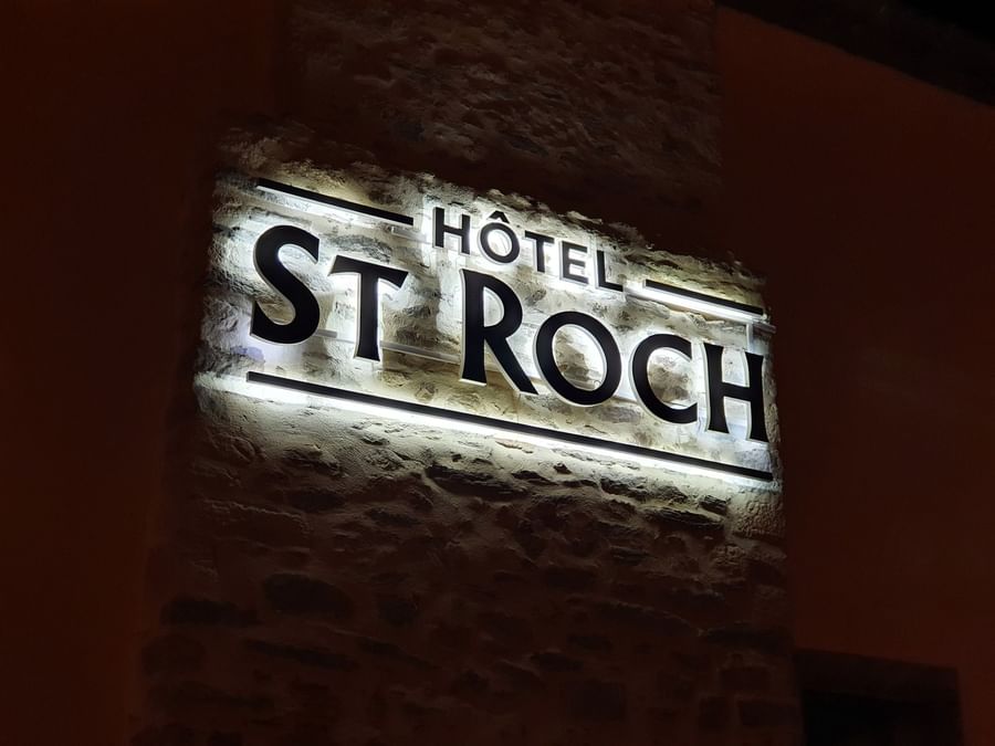 Close up image of Sign name of Hotel Saint-Roch on the wall