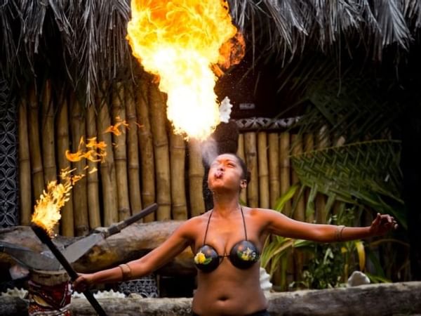 A traditional dancer blowing fire at Warwick Fiji