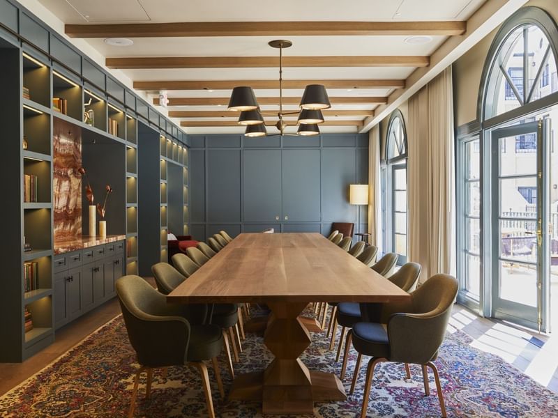 La Biblioteca meeting room at El Prado Hotel, with a long wooden table and bookshelves