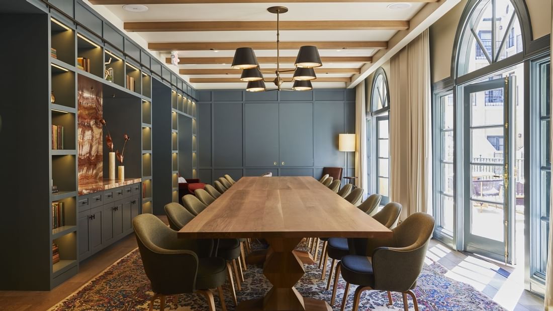 La Biblioteca meeting room at El Prado Hotel, with a long wooden table and bookshelves