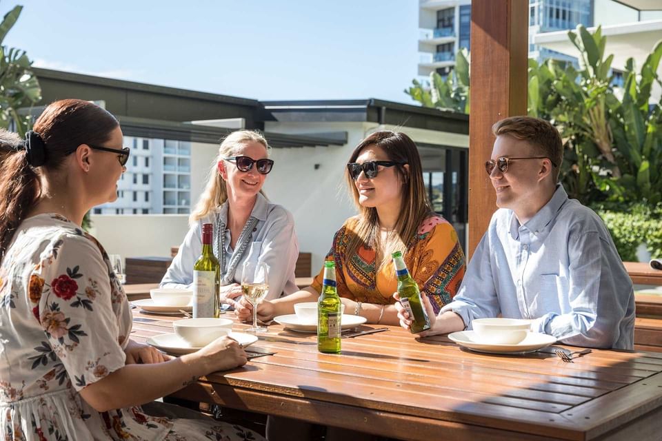 People enjoying outdoor BBQ Brisbane at Alcyone Hotel Residences