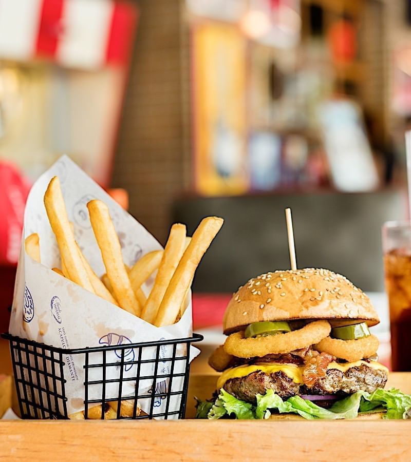 Burger served with fries and coke at Mundo Imperial