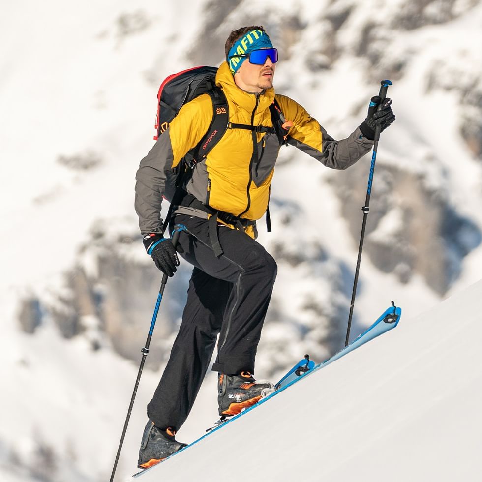 Man ascending on snowy slope near Falkensteiner Hotel Schladming