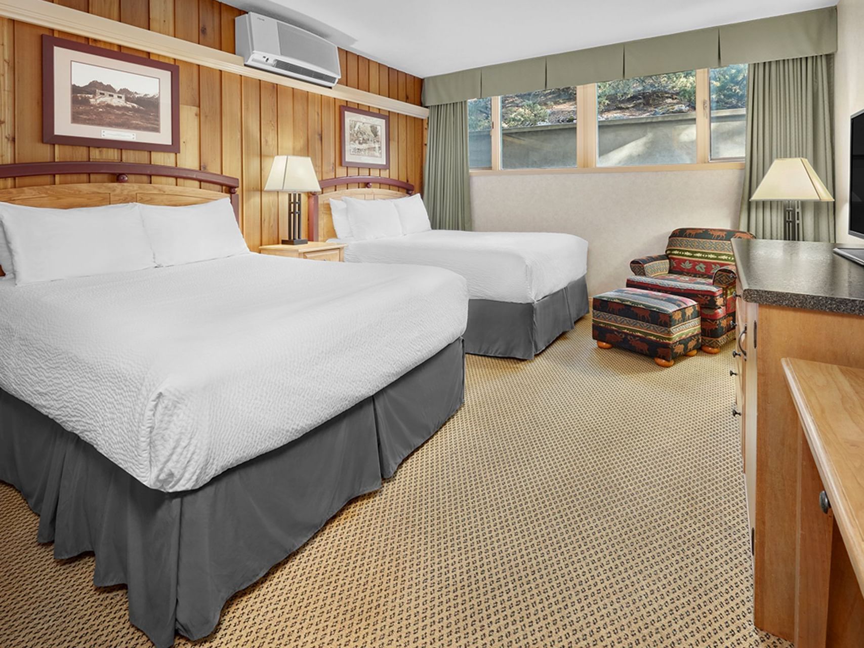 Economy Room with cozy beds and carpeted floor at Fairmont Hot Springs Resort