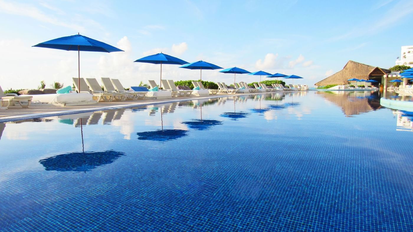 Loungers arranged by outdoor pool area at Live Aqua Cancún