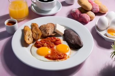 Yummy breakfast plate served with eggs, potatoes, and other goodies at Porta Hotel Del Lago