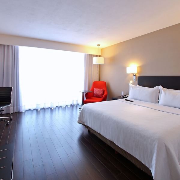 King bed & lounger in Executive Room at Fiesta Inn
