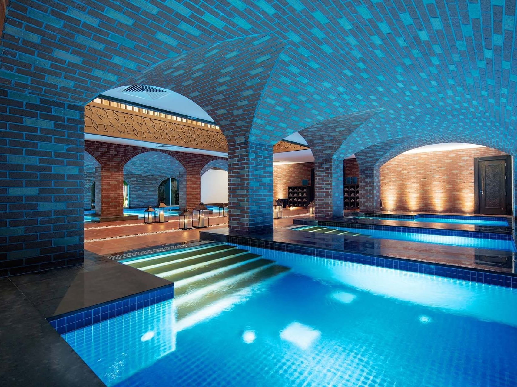 Indoor pool with arched brick ceilings in BeFine Spa at Titanic Deluxe Golf Belek