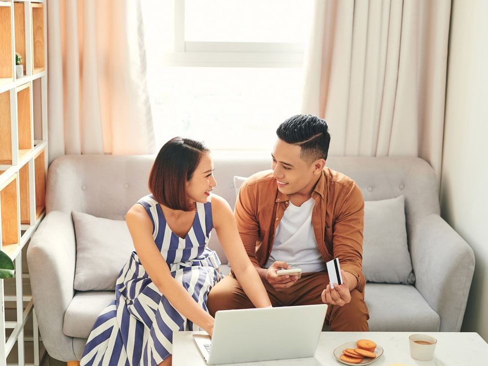 Couple browsing on the laptop in lounge at Imperial Lexis Kuala Lumpur