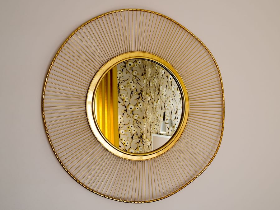 A mirror on the wall at Hotel Armen Le Triton