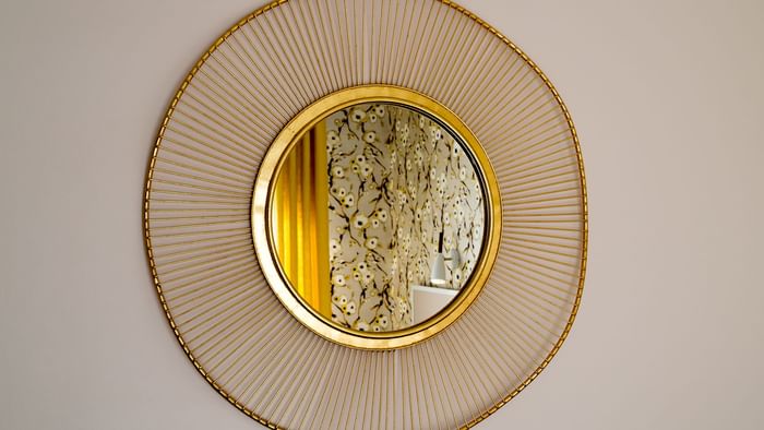A mirror on the wall at Hotel Armen Le Triton