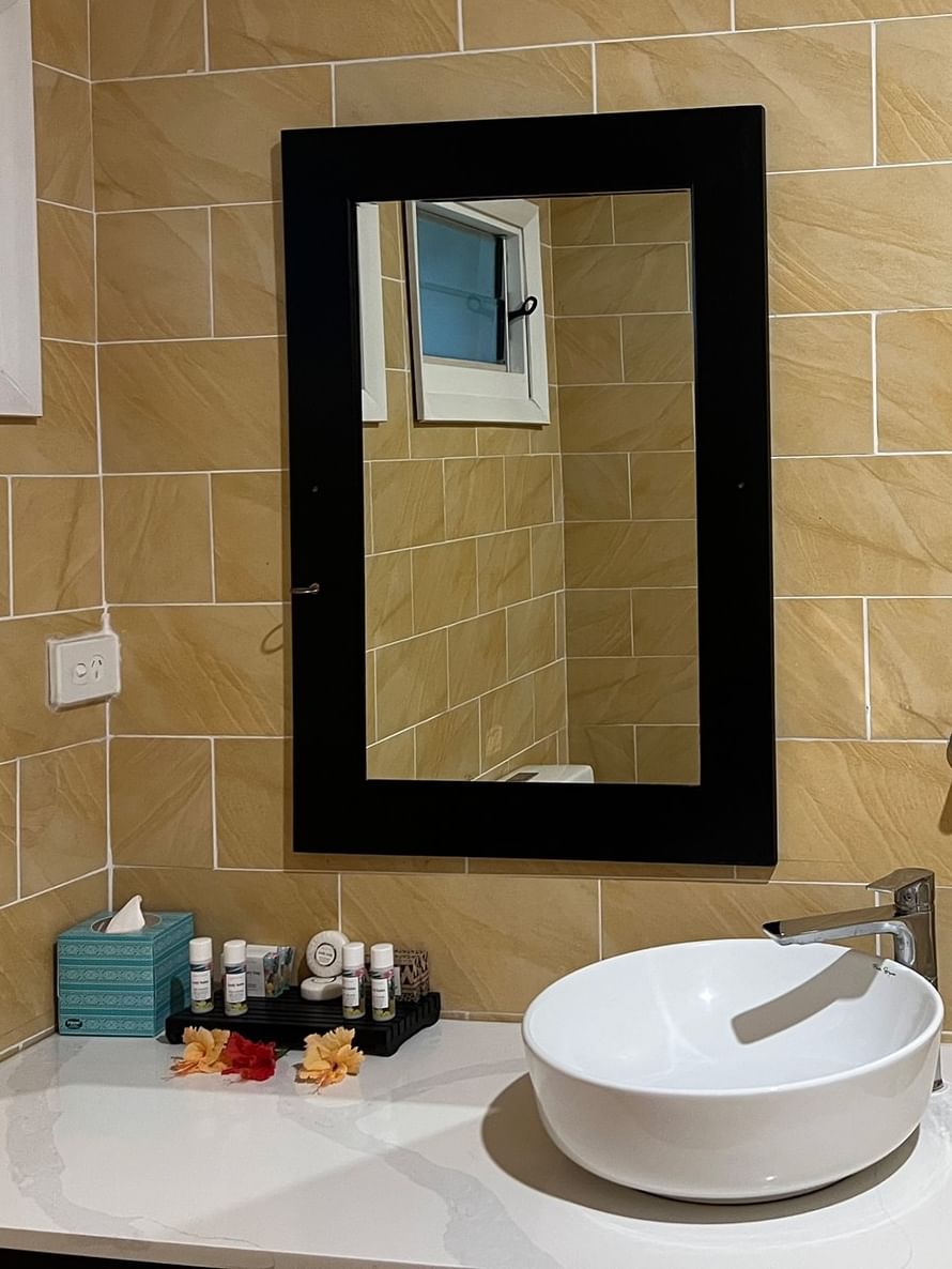 Bathroom sink with mirror and towel in the Ocean View Villa at Tambua Sands Beach Resort in Sigatoka.