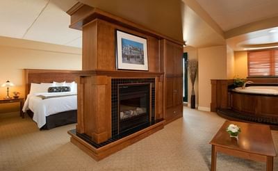 Fireplace, jetted tub & bedroom in Honeymoon Suite at Temple Gardens Hotel & Spa