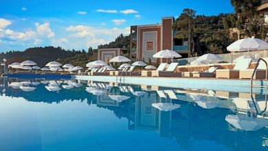 Outdoor infinity pool at Kairaba Mythos Palace at sunset