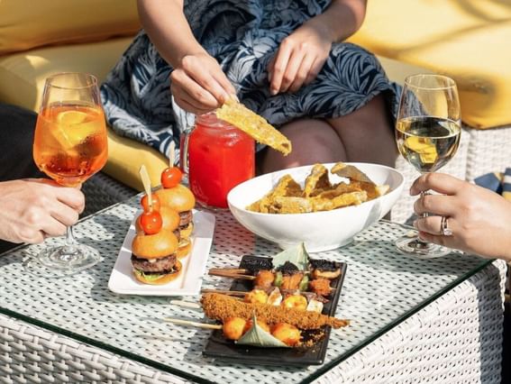 A group having wine and enjoying burgers fried food at Park Hotel Group