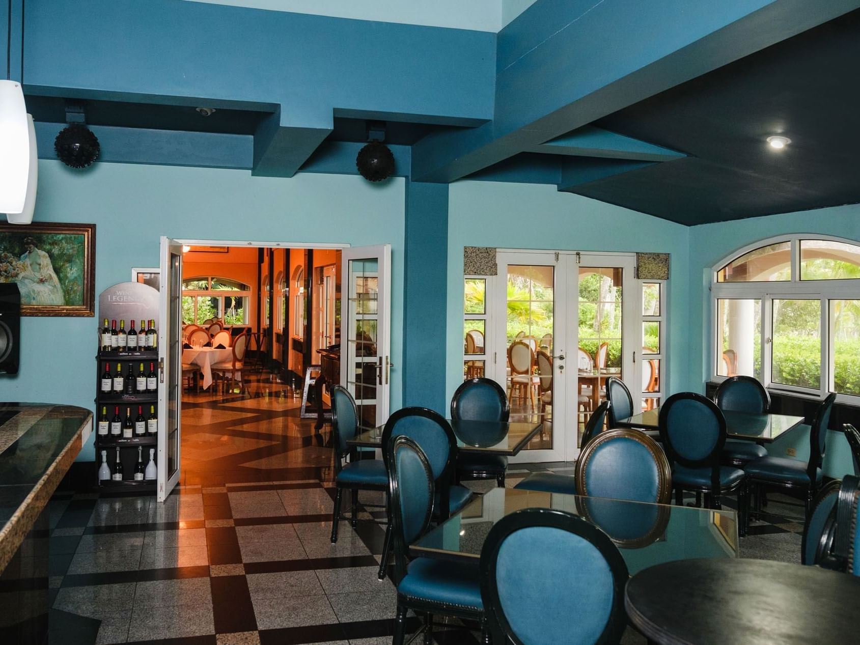 Bar Azul with dining area and bar shelves at Las Olas Beach Resort