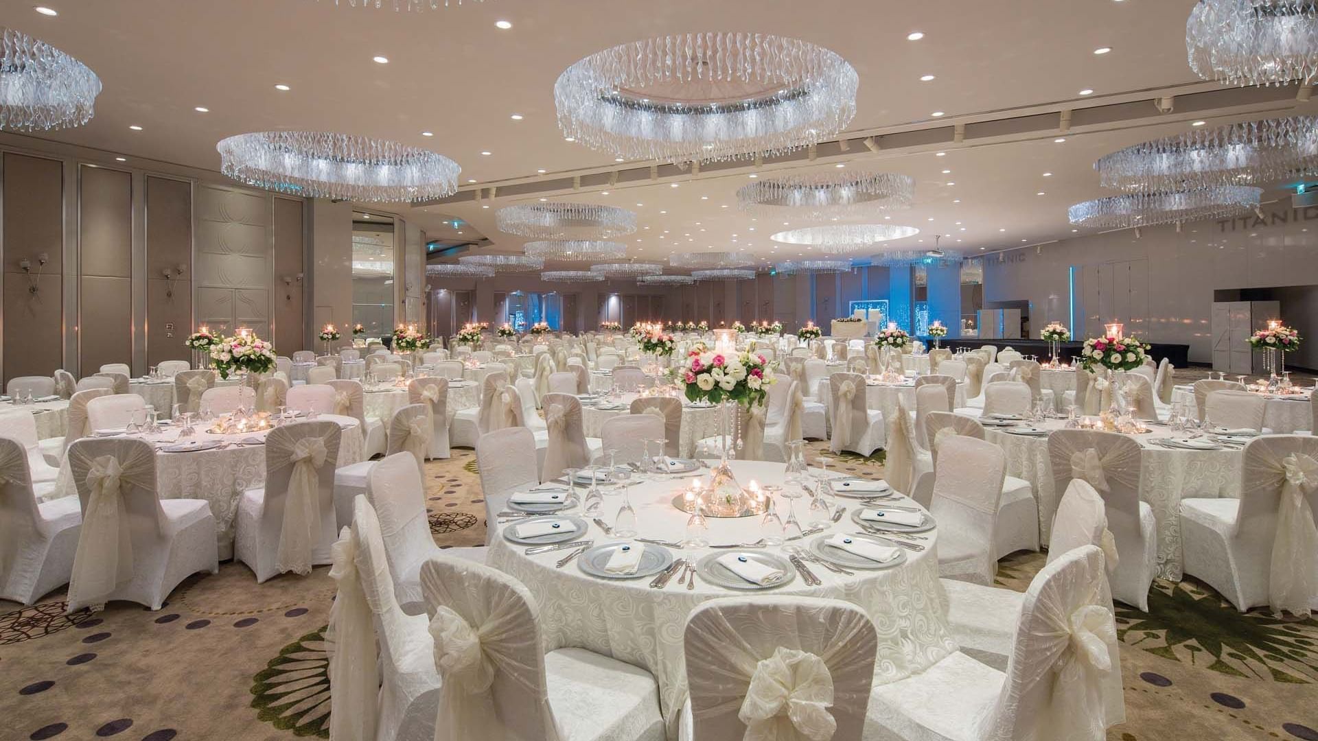 Interior of wedding hall with round chairs and tables in Pacific Meeting Hall at Titanic Deluxe Lara