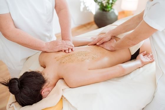 A lady getting a body massage at Schloss Hotel Pichlarn