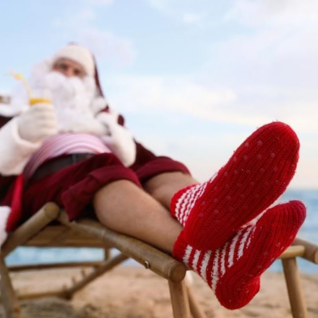 What Is Twixmas featuring a relaxing Santa on the beach