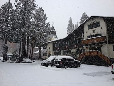 The hotel exterior & parking in winter at Alpenhof Lodge