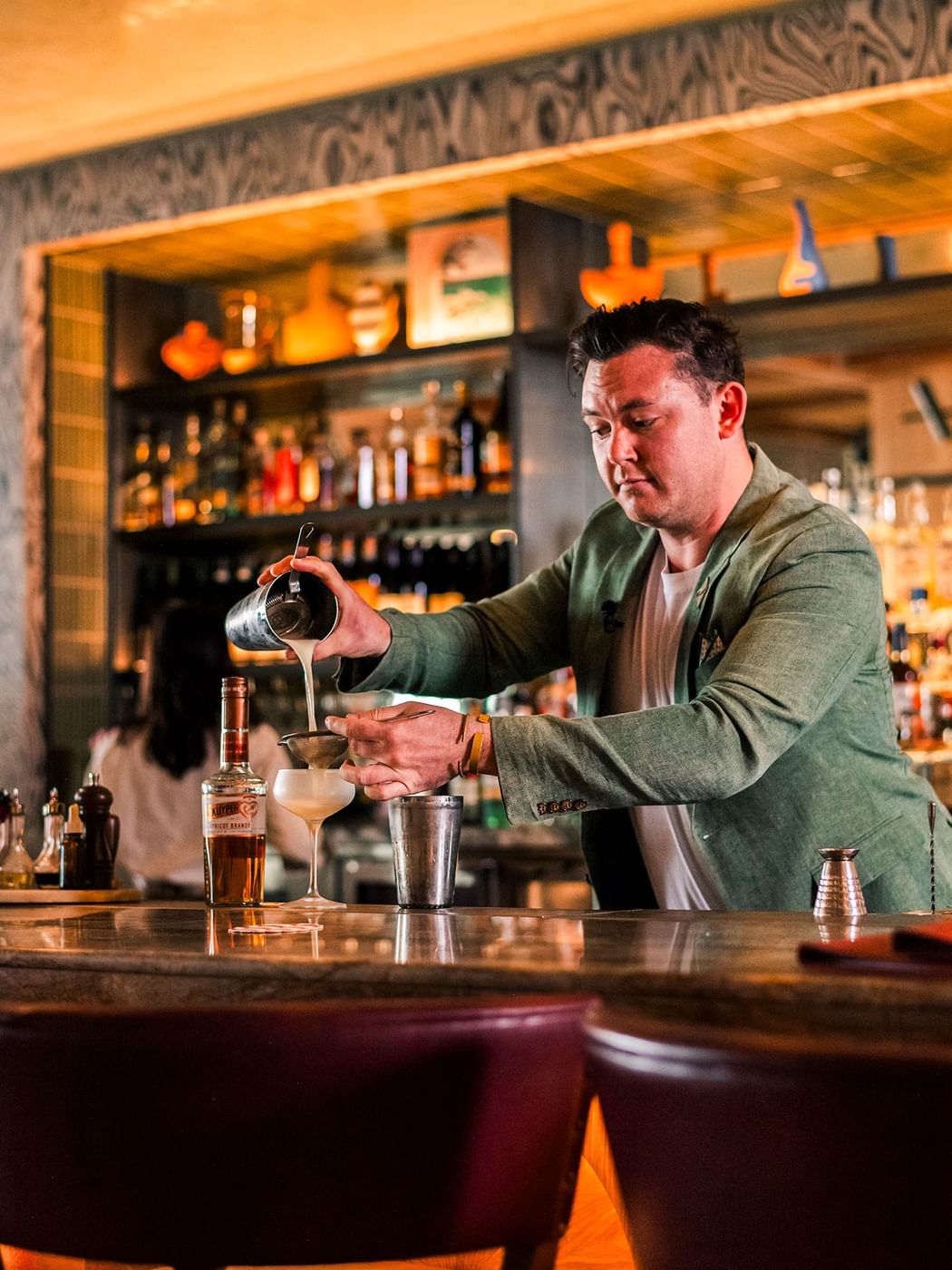 Cibaria\'s 55 North Bar at Elysium Manly with a bartender in a green jacket pouring drinks, elegant Italian restaurant Manly