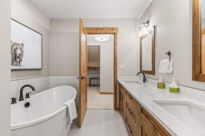 Luxury bathroom with a bathtub and double vanity at Spring Creek Vacations Canmore Condos