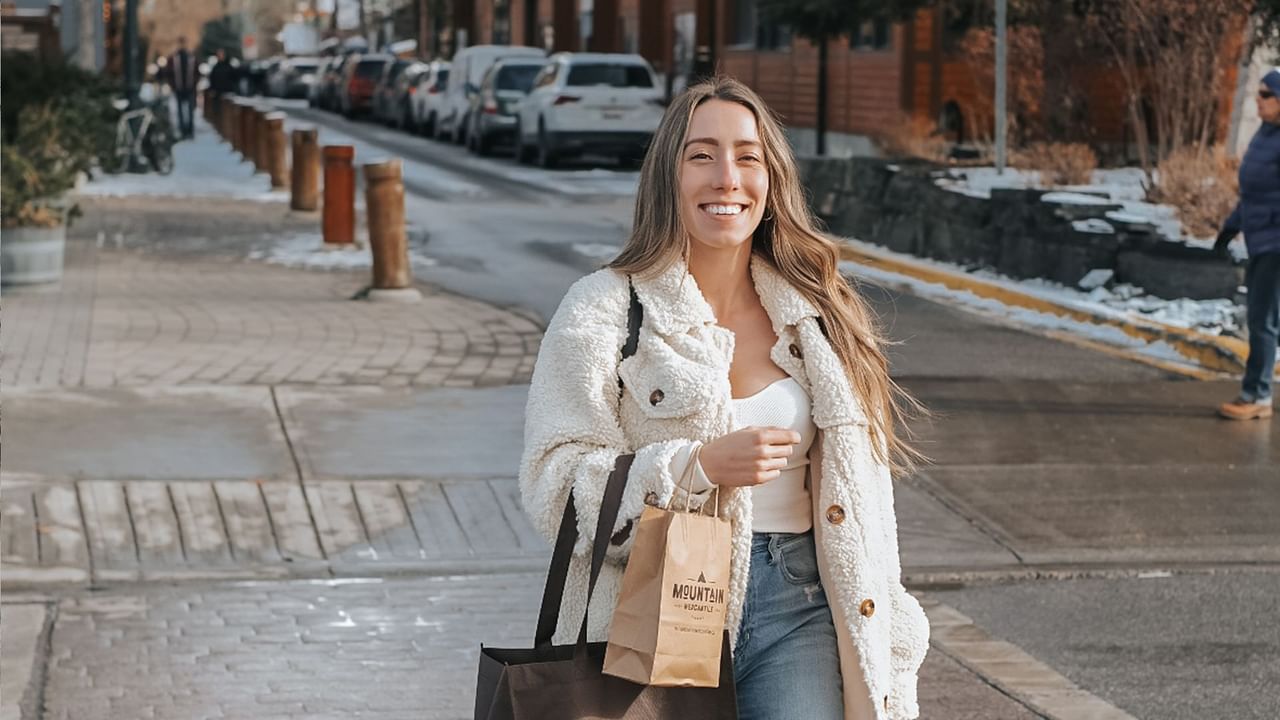 A person walks down the street while enjoying a Canmore shopping trip.