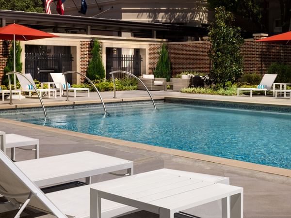 Pool beds by the swimming pool at Warwick Melrose Dallas