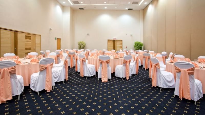Banquet tables set up for an event room at Gamma Plaza Ixtapa
