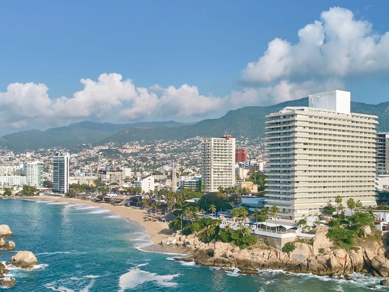 High-angle view of Fiesta Americana Acapulco Villas with city and sea